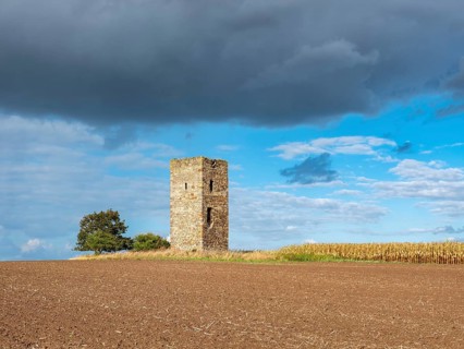 The Blue Tower in a ploughed field in autumn, medieval watchtower in the Magdeburger Börde, blue