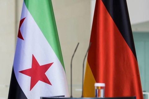 The flags of the Syrian Arab Republic and the Federal Republic of Germany in front of a joint press