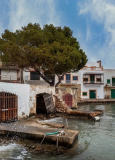Old and dilapidated boat shelters that are not being used, old port area in Portocolom on the east