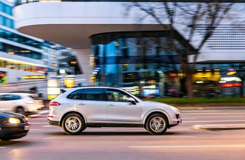 Car at night in front of an urban environment with modern architecture, driver. Stuttgart,