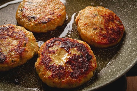 Fried chicken cutlets, with vegetables, in a frying pan, homemade, no people