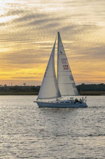 Sailboat sailing on the Tolomato River near Vilano Beach, Florida at sunset