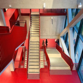 Staircase with signal red color scheme in seminar building H of Bochum University, Ruhr area, North