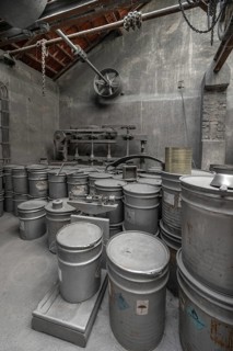 Metal barrels covered with zinc dust in the filling and weighing room for zinc powder of a metal