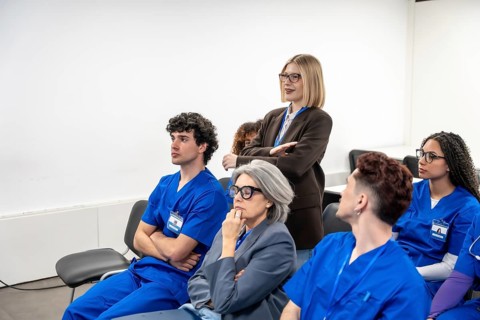 Healthcare professionals and students actively participating in an educational conference, focused