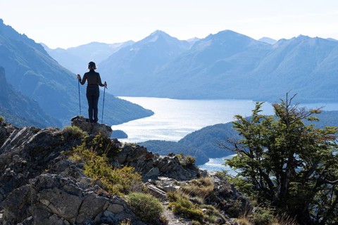 Hiker enjoys views of Andean lakes and mountains from Cerro Goye in Nahuel Huapi National Park,