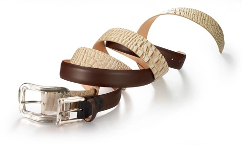Intertwined belts in different colors against a white background, studio shot