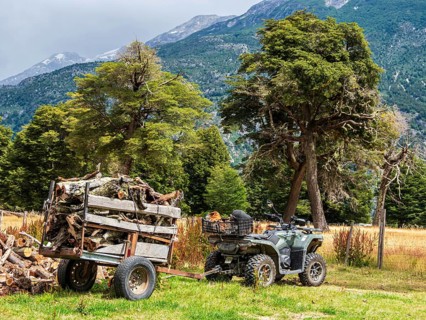 Quad bike with trailer transports firewood, farm Refugio Rio Nadis, Patagonia, Chile