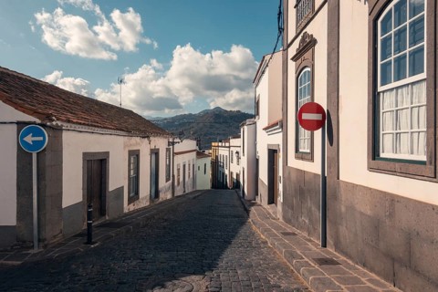 A picturesque cobblestone street in Arucas, Gran Canaria showcases traditional architecture in the