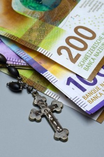 Crucifix and banknotes, Swiss francs, church and money