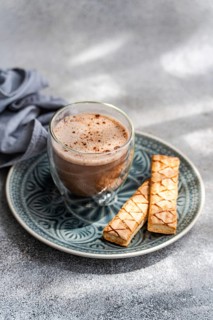 A delightful scene featuring a crisp, delicious puff pastry filled with apricot jam on a decorative
