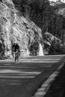 Road bike rider in spring in the Allgäu against the picturesque backdrop of the Alps, Bavaria,