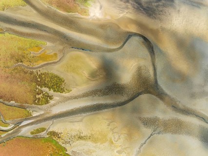Streams and marshes at low tide in the wetlands of the Walvis Bay lagoon. Aerial view. Drone shot.