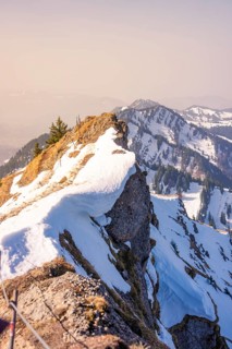 Snowy rocks and trees on a mountain peak with a wide view, Hochgrat Mountains, Allgäu Alps,