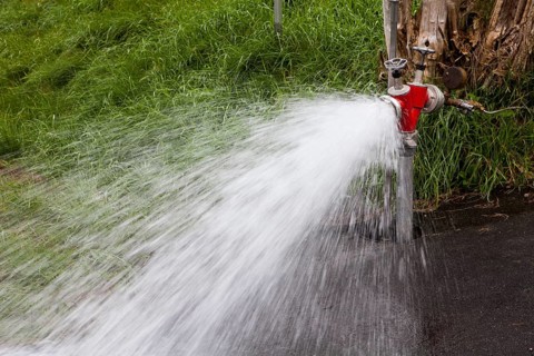 Splashing water out of a hydrant, Hesse, Germany