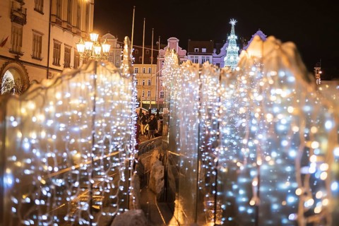 Christmas fair in the market square of Wroclaw (in Poland) with illumnated christmas tree over the