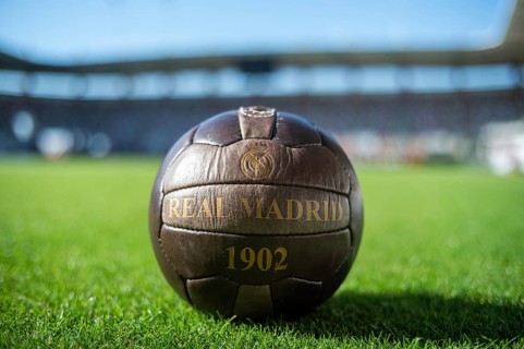 LUBIN, POLAND - SEPTEMBER 14, 2024: Old soccer ball with writing Real Madrid 1902 on the grass.