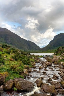 Stream, lakeside, rescue helicopter flying at dusk, Gap of Dunloe mountain pass, Killarney, Ring of