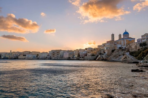 View of the village with the Greek Orthodox church of Agios Nikolaos, Asteria Beach, at sunset with