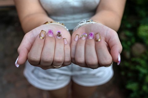 Colourful fingernails of a young woman, on a black background, Baden-Württemberg, Germany