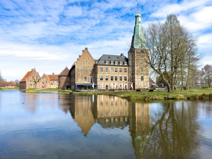 View over moat at historic moated castle from Renaissance Raesfeld Castle reflected in Wassergraben