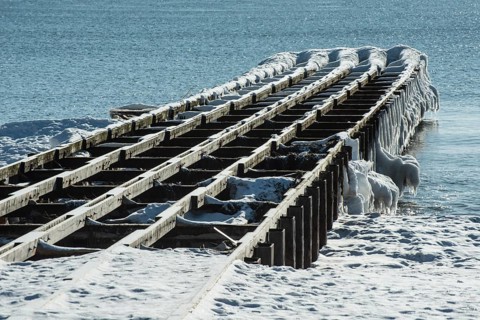 Ice-covered bathing jetty, partially dismantled over the winter, in Ystad, Skåne County, Baltic