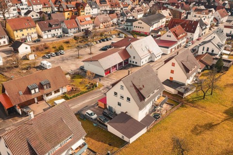 Small town seen from the air with brick houses and a quiet residential area in autumn weather, fire