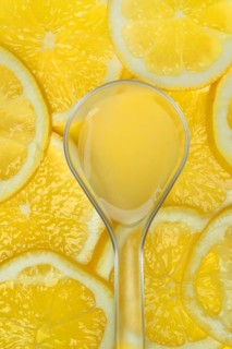 Lemon juice in ladle and lemon slices, Citrus x limon