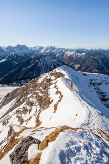 Two ski tourers at the summit of Schafreuter, view of snowy mountain panorama, Karwendel, Tyrol,