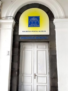 Entrance and logo sign to Mauritius Postal Museum Philatelic Bureau with Blue Mauritius stamp, Port