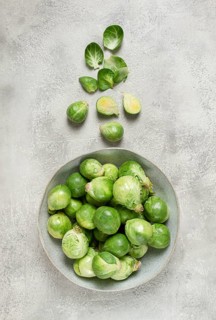 Fresh Brussels sprouts, raw, top view, on a gray table, no people