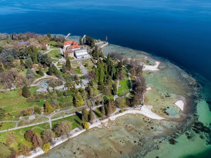 Aerial view of the island of Mainau at low tide with spring-like vegetation, district of Constance,