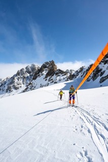 Ski tourer with rope, rope team on the Vadret da Porchabella glacier on the ascent to the summit of
