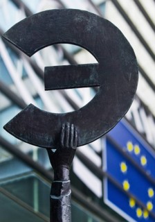 The bronze statue entitled Europe by May Claerhout holds up the euro symbol in front of the EU