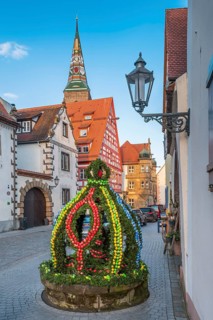 Alley with Easter fountain, half-timbered houses and cobblestones in the old town centre in the