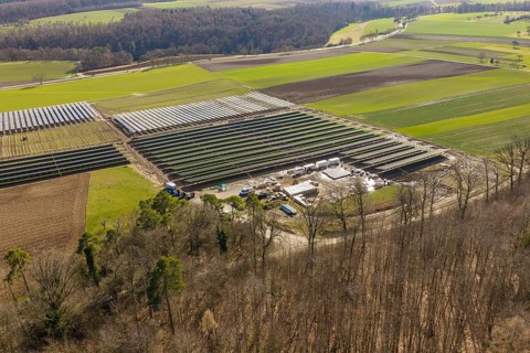 Solar system in a rural area, from above with surrounding fields and trees, Agri PV Bau für