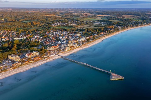 Aerial view over Seebrücke, pier and sandy beach at seaside resort Scharbeutz along the Baltic Sea,
