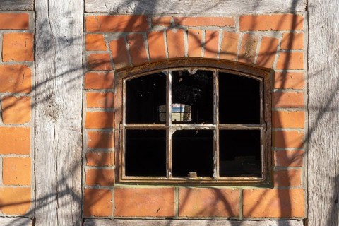 An old rusty window frame of a half-timbered barn, Wildeshauser Geest, Bassum, Diepholz, Lower