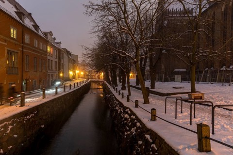 Canal Frische Grube next to St Nicholas' Church in the snow and at night, Hanseatic city of Wismar,