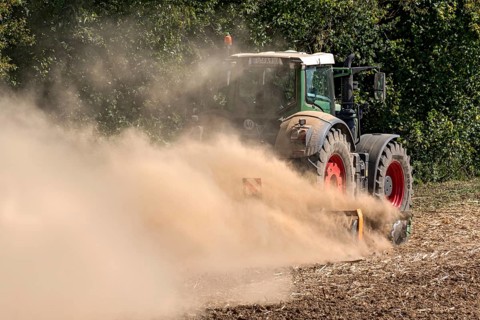 Tractor with plough digging up dried-out soil, large cloud of dust, dust, dry, field, soil,