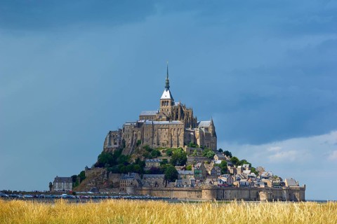 Picturesque view of Mont Saint-Michel on an island with medieval architecture, summer, Le