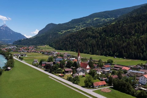 Drone shot, view of village with parish church, Schönwies, Oberinntal, Tyrol, Austria
