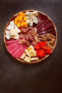 Assortment of cheese meat cuts, on a plate, top view, no people