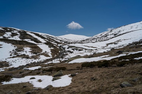 Serene snowy landscape of Sierra de Gredos showcasing the convergence of snow-covered ridges under