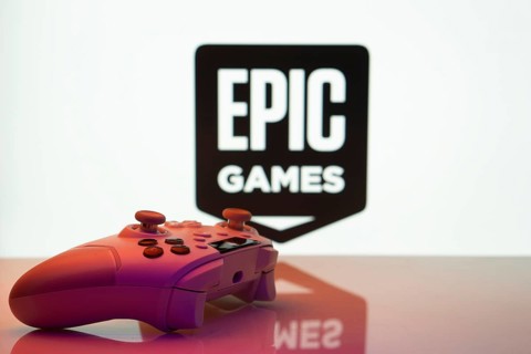 Game controller in front of Epic Games logo on a white background