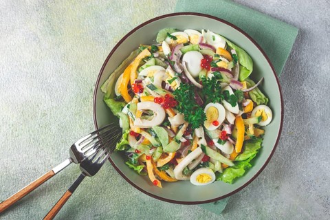 Salad with squid, fresh cucumber, eggs, sweet pepper, red onion, with dressing, homemade, no people