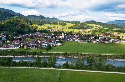 Drone shot, view of the village with parish church, Kössen, Leukental, Tyrol, Austria