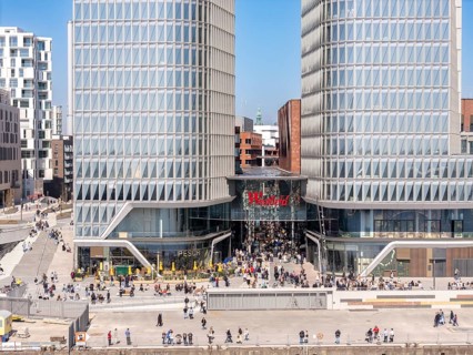 Aerial view of Westfield shopping centre with glass facades surrounded by urban landscape in