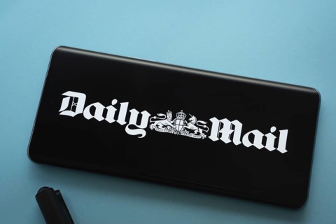 The logo of the Daily Mail is displayed on a smartphone screen