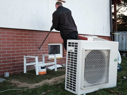 The installer installs the heat pump in a single-family house in Tymowa, Poland